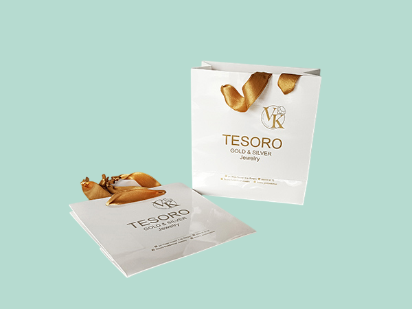 Luxury branded paper bags with cord and satin ribbon handles